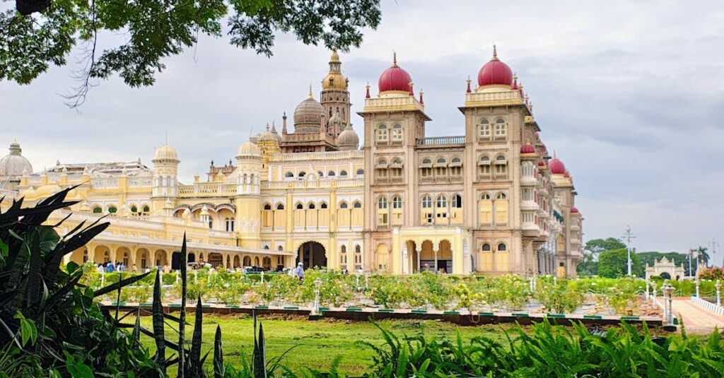 Mysore Palace surrounded by lush greenery on a clear day, showcasing Indian architecture.